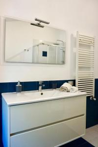 a bathroom with a white sink and a mirror at Villa Pola Liberty house Mondello in Palermo +35 photos