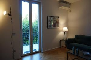 a living room with a couch and a large sliding glass door at Villa Pola Liberty house Mondello in Palermo