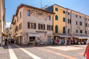a group of buildings on a city street with people at Ca'Dinora - Venetia apartment - in Bardolino
