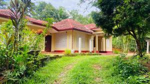 a yellow house with a red roof at The Old Manor - Weligama in Weligama