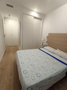 a bedroom with a large bed and two closets at Marina3 - Playa de Daimús - Ganador Traveller Awards 2026 in Daimuz +14 photos