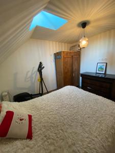 a bedroom with a bed with a camera on a tripod at Coco Bonnevie in Murat