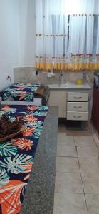 a kitchen with two twin beds and a sink at Pousada Ninho da Águia in Campos do Jordão