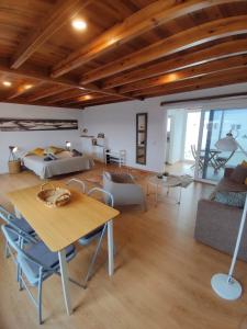 a living room with a bed and a table at Loft Casa Burgao in Caleta de Caballo