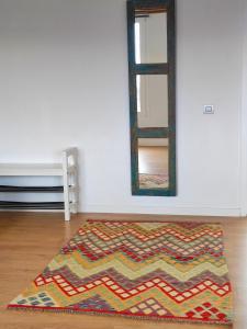 a rug on the floor in a room with a mirror at Loft Casa Burgao in Caleta de Caballo +14 photos