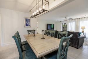 a dining room and living room with a wooden table and chairs at Pet Friendly, Patio, Close to Beach, QG515 in Hilton Head Island