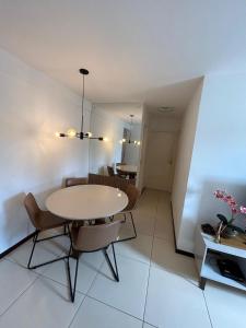 a dining room with a table and some chairs at Apartamento próximo a praia in Maceió