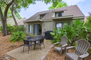 a table and chairs in front of a house at Pet Friendly, Patio, Close to Beach, QG515 in Hilton Head Island