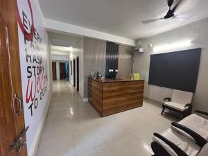 a conference room with a reception desk and a flat screen tv at Hotel Crystal INN in Bhubaneshwar +22 photos
