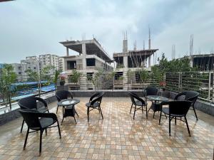 a group of chairs and tables on a roof at Hotel Crystal INN in Bhubaneshwar