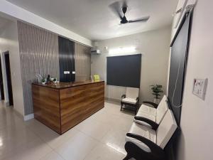 a meeting room with a board and a couch and a podium at Hotel Crystal INN in Bhubaneshwar