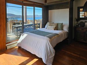 a bedroom with a large bed and a balcony at Tremblant Prestige - Altitude 172-8 in Mont-Tremblant