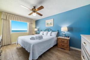 a bedroom with a bed and a window with the ocean at Driftwood Towers 5F in Gulf Shores