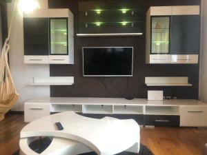 a living room with a tv on a wall at Cozy 150m2 Apartment , 2 Parking places in Belgrade