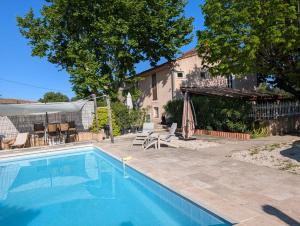 a swimming pool in front of a house at Pooh’s Belle in Grimaud