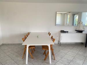 a white table and chairs in a room at Seasons & Connections in Balatongyörök +12 photos