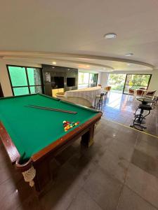 a pool table in the middle of a living room at Espaço Life - Eventos in Curitiba