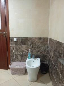 a bathroom with a toilet and a sink at Elegant apartment in Rabat in Rabat +6 photos