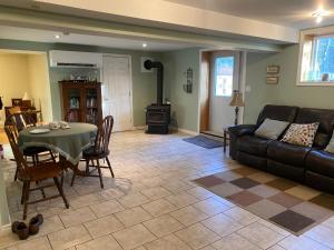 a living room with a table and a couch at Sleepy Pines Place in Bridgewater