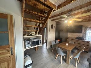 a kitchen and dining room with a table and chairs at ''Kaszebe ''Domek letniskowy całoroczny z jacuzzi nad jeziorem Raduńskim in Borzestowska Huta