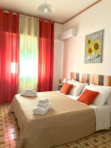 a bedroom with two beds with towels on them at Casa Puglia in Giardini Naxos