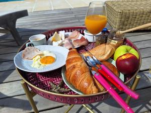 a tray of breakfast foods and a glass of orange juice at Villa Sisyphe chambre d'hôtes "la Mariette" in Le Thoronet