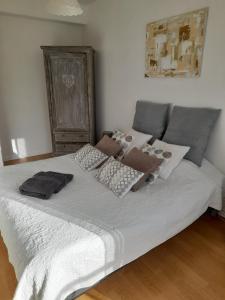 a bedroom with a white bed with boxes on it at Perigueux T2 proche du quartier historique in Périgueux