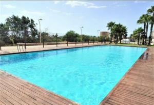 a large pool with blue water in a park at Spa & Jacuzzi frente al mar in La Manga del Mar Menor