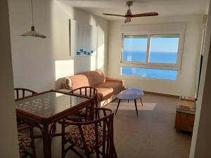 a living room with a couch and a table at Spa & Jacuzzi frente al mar in La Manga del Mar Menor