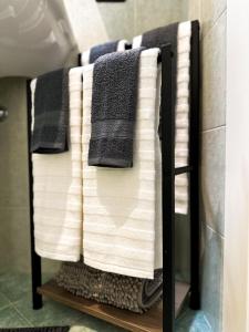 a towel rack with towels on it in a bathroom at Casa Camoscio by Maggiore Living in Baveno