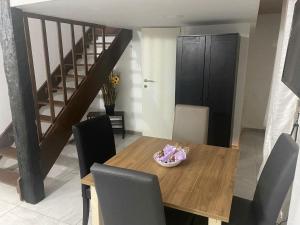 a dining room with a wooden table and chairs at Tal Landier Accommodation in Qormi