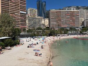 a group of people on a beach in a city at New,mountain & sea view 3 guests with private Garage in Beausoleil