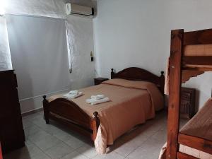 En eller flere senge i et værelse på Departamentos Stella