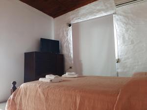 En eller flere senge i et værelse på Departamentos Stella