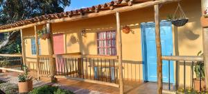 a porch of a house with a blue door at Cabaña Umpalita para 4 cuatro personas in Los Santos