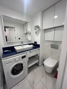 a bathroom with a washing machine and a sink at Orbi city bloke A in Angisa +55 photos