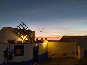 a group of people sitting on the roof of a building at Casa Cueva EL ATARDECER in Campo de Criptana