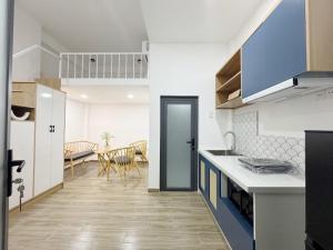 a kitchen with white counters and a dining room at Urbanest Saigon in Ho Chi Minh City +18 photos