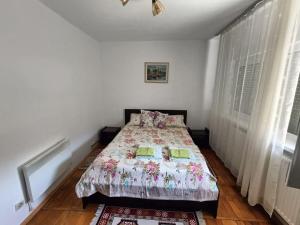 a bedroom with a bed with a comforter on it at Apartament Alexandra in Orşova