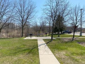 a park with a bench and a picnic table at Auburn Hills Extended Stay Inn in Auburn Hills