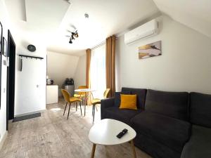 a living room with a black couch and a table at G17-1 Palanga in Palanga