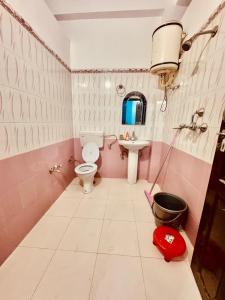 a pink bathroom with a toilet and a sink at SamathaStay in Munsyari +56 photos