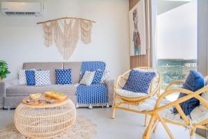 a living room with a couch and chairs and a table at Fantastic Apartment/Beach Front Luxury in Cartagena de Indias