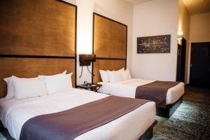 Voodi või voodid majutusasutuse AX Hotel toas