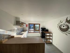 a kitchen with a large wooden island in a room at Gite Le Petit Nid - 3 chambres in Couvin