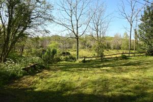 a field of grass with a fence and trees at La Palombrera in Treceño +40 photos