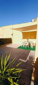 a patio with a table and chairs next to a building at Affittacamere Girasole in Modugno