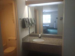 a bathroom with a sink and a mirror at 2 Double Beds Hotel Studio 134 in Livingston