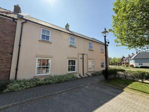 a house with a street light in front of it at Arthurs Escape - Part of the The Bay Filey Holiday Village with pool, gym and direct beach access, pub, restaurant, tennis and meadows walks in Filey