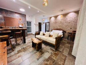 a living room with a couch and a piano at City Retreat Studio X in Arusha